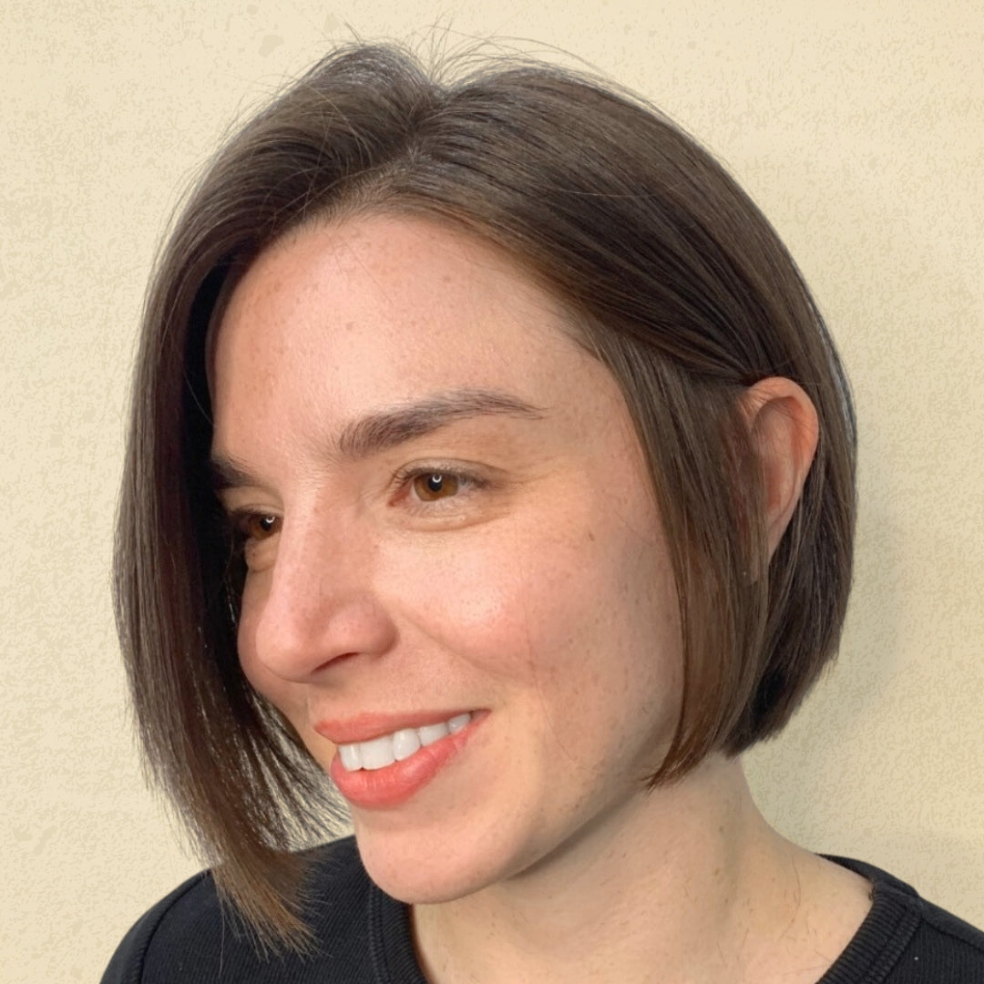 This is an image of a brown haired girl showcasing her new, stylish, haircut done by a stylist at Ippodaro Natural Salon, in San Antnonio, Texas.