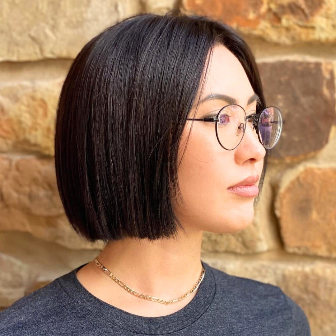 This is an image of a dark haired girl showcasing her new, stylish, haircut done by a stylist at Ippodaro Natural Salon, in San Antnonio, Texas.