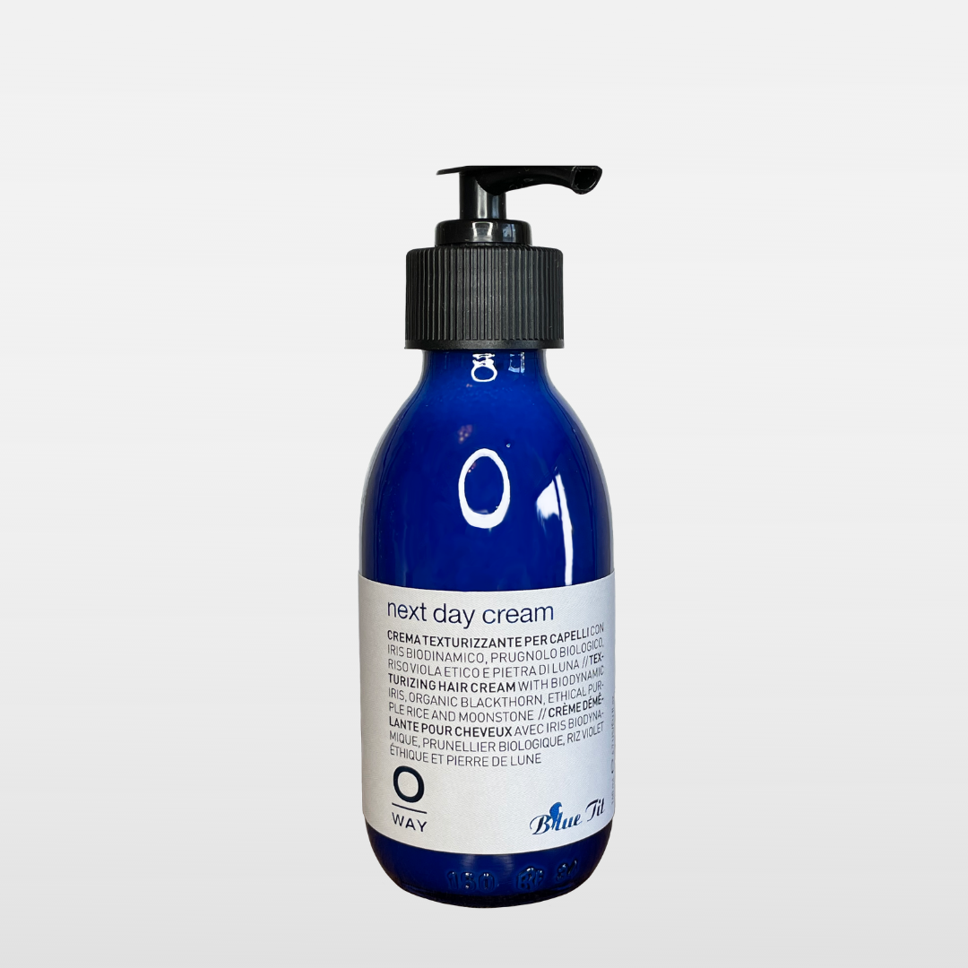 Oway Blue Tit Next Day Cream 4.7oz, 140ml. In a blue glass bottle with white label, blue and black lettering, black pump. Available at Ippodaro Natural Salon, San Antonio, TX