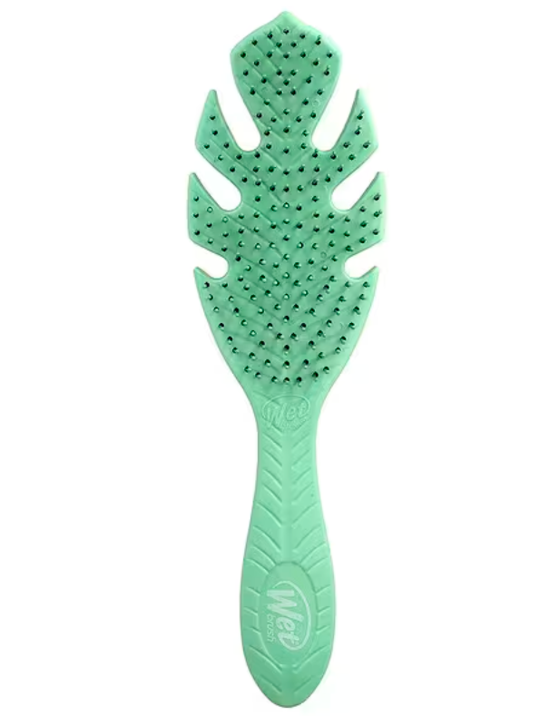 A mint green silicone hairbrush with a leaf-shaped head and textured handle, shown against a plain white background.